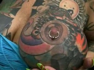 Busty tattooed whore Blackwidow XXX sucking deeply in load of shit
